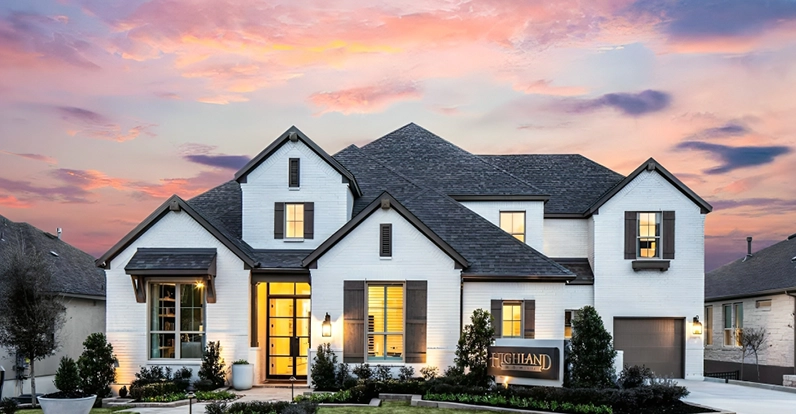 Luxury home with a modern design against a vibrant sunset sky.