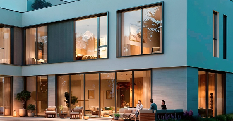 Modern luxury home exterior with large windows and outdoor seating area.